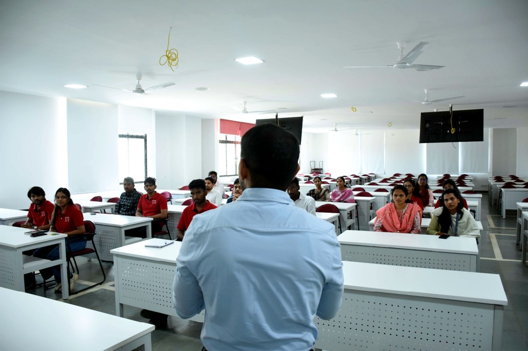 A mentor addressing students at the AI Tech Coach launch