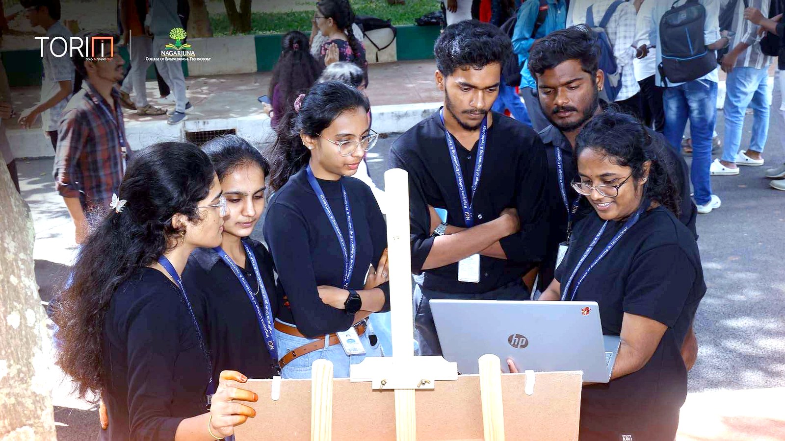 A team huddled around a laptop finalising their demo
