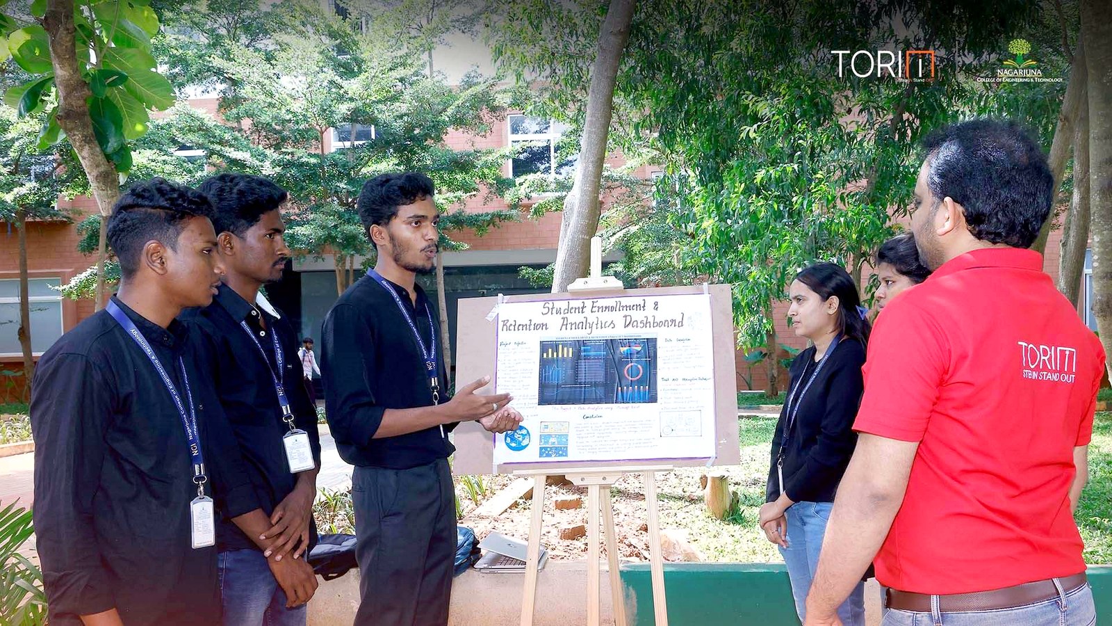 Students presenting their project poster to a mentor